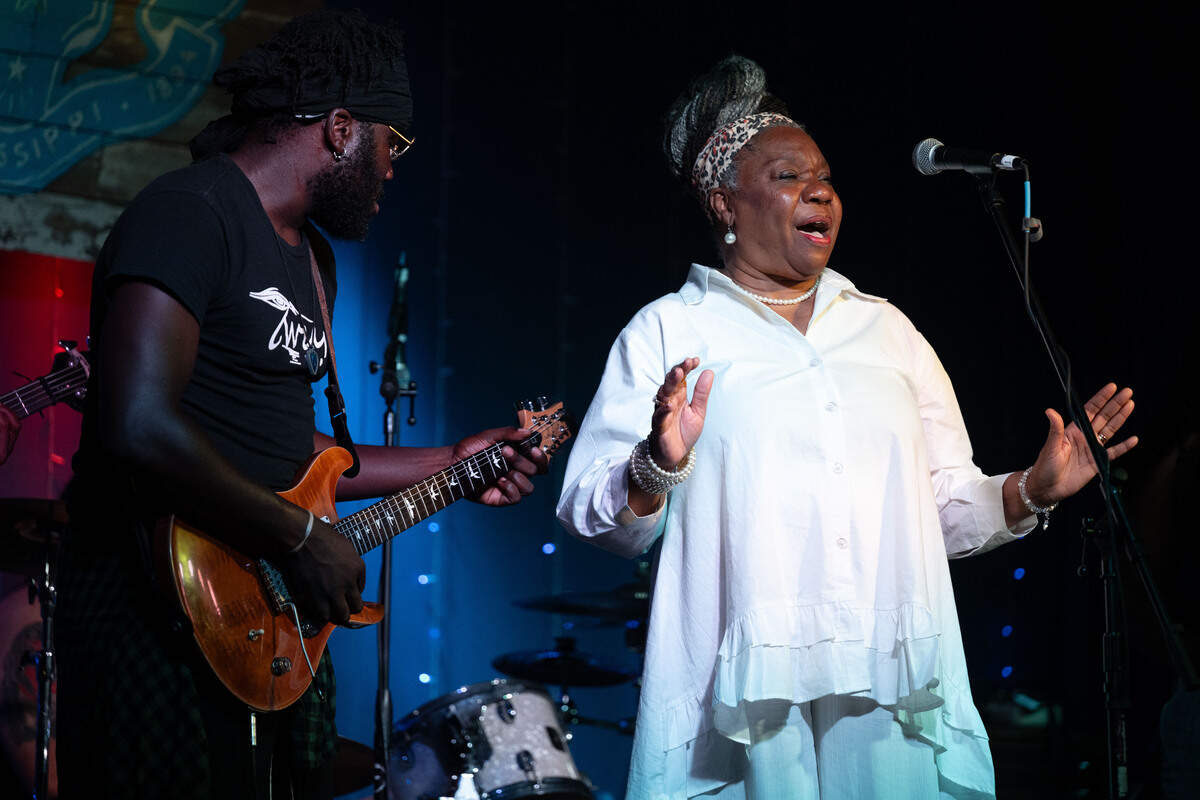Sherry Hill, right, is invited on stage to perform with Twurt Chamberlain, left, during a Juneteenth celebration at 100 Men Hall in Bay St. Louis on Friday, June 19, 2026.