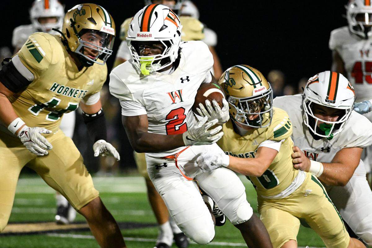 West Harrison’s Austin McInnis (2) picks up yards Friday in the Hurricanes’ win over Poplarville.