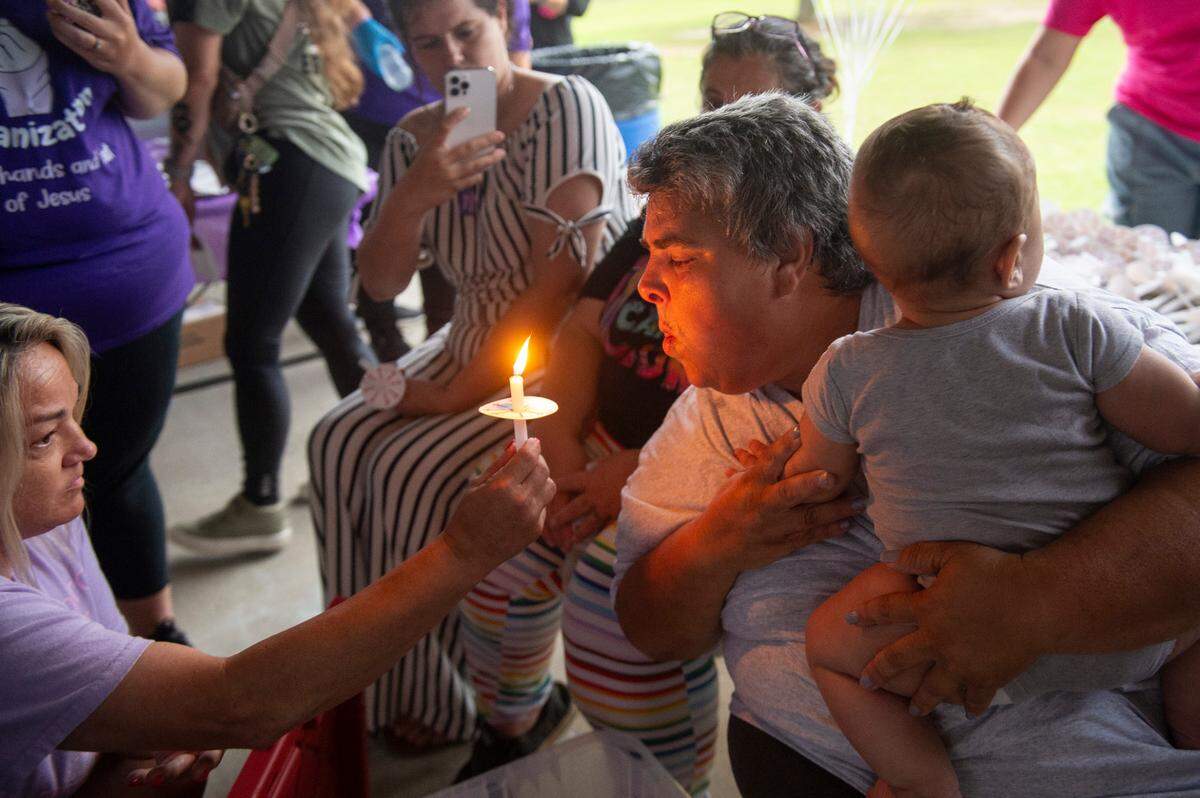 Vickie Wedgeworth Hutcherson, the mother of Gracelynn Vick, blows out the first candle lit in honor of her daughter during a candlelight vigil for Gracelynn at Saucier Park on Tuesday, April 22, 2025.