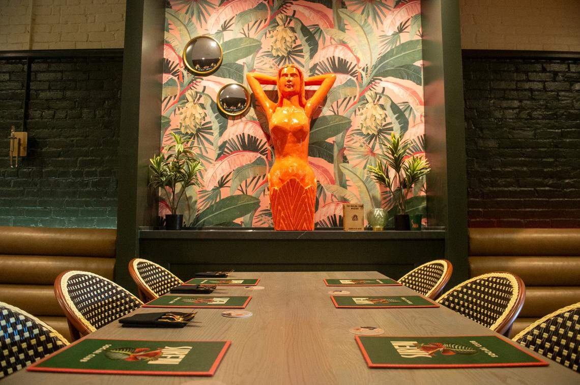 A hightop seating area is punctuated with eye-catching art at Siren Social Club inside Hotel Vela in Gulfport.