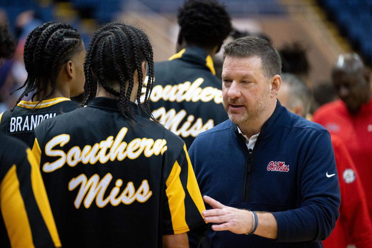 Mississippi head coach Chris Beard shakes hands with Southern Mississippi players after the Rebels’ victory Saturday.