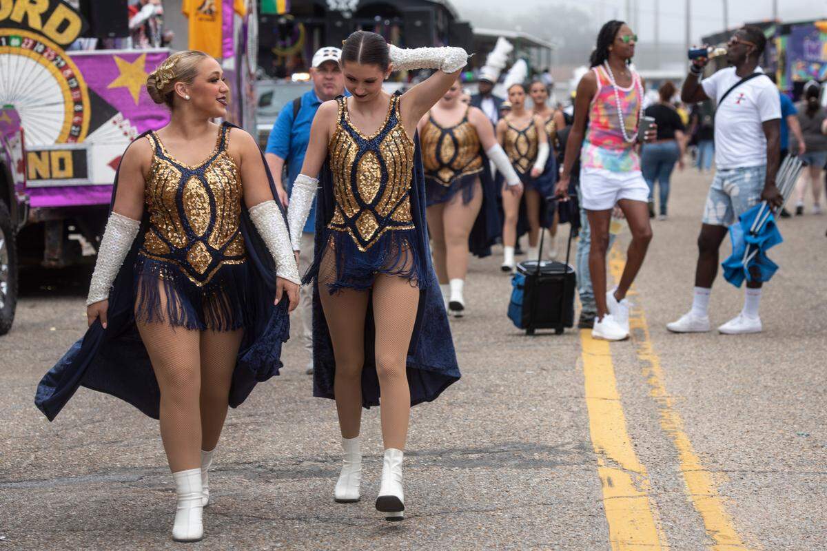 Dancers for MGCCC walk through the float staging area before the Gulf Coast Carnival Association Mardi Gras parade in Biloxi on Tuesday, Feb. 21, 2023.