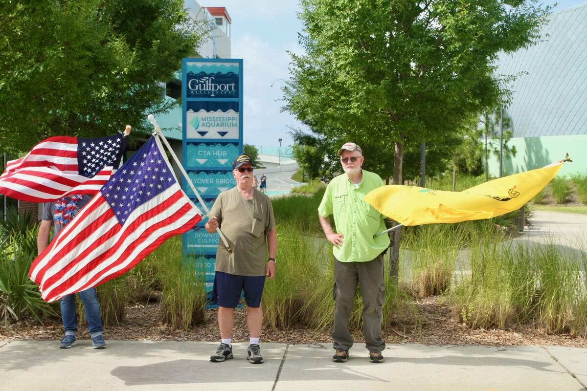 A few people came to a ‘No Kings’ Day protest June 14, 2025, in Gulfport to support President Donald Trump, whose administration nationwide protests targeted. Retired Seabee Robert Charles Hall Sr., right, of Gulfport, held a “Don’t Tread On Me” flag and said he was carrying a Glock pistol in case police needed help, but the protest was peaceful.