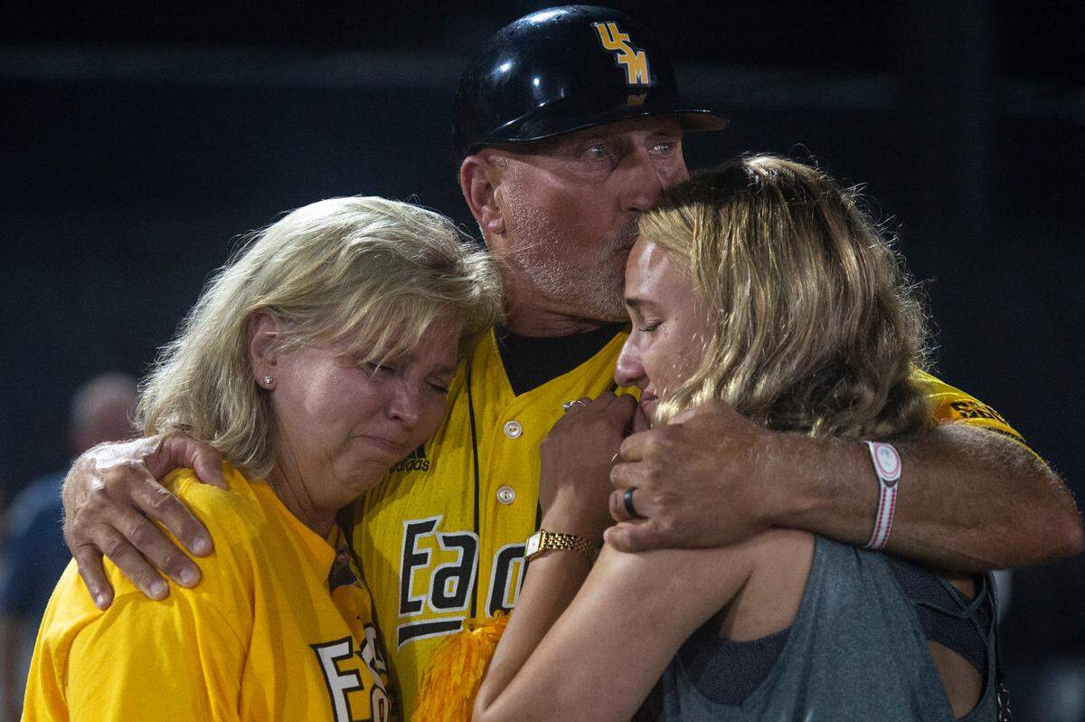 Southern Miss Head Coach Scott Berry hugs his family after Southern Miss lost to Tennessee in the NCAA Super Regional at Pete Taylor Park in Hattiesburg on Monday, June 12, 2023. Berry is retiring after the season.
