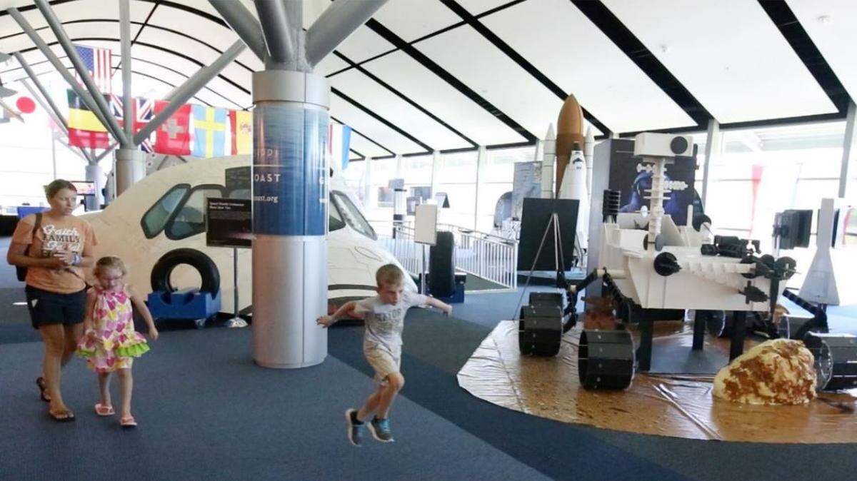 A family goes through the space gallery at Infinity Science Center in Hancock County.