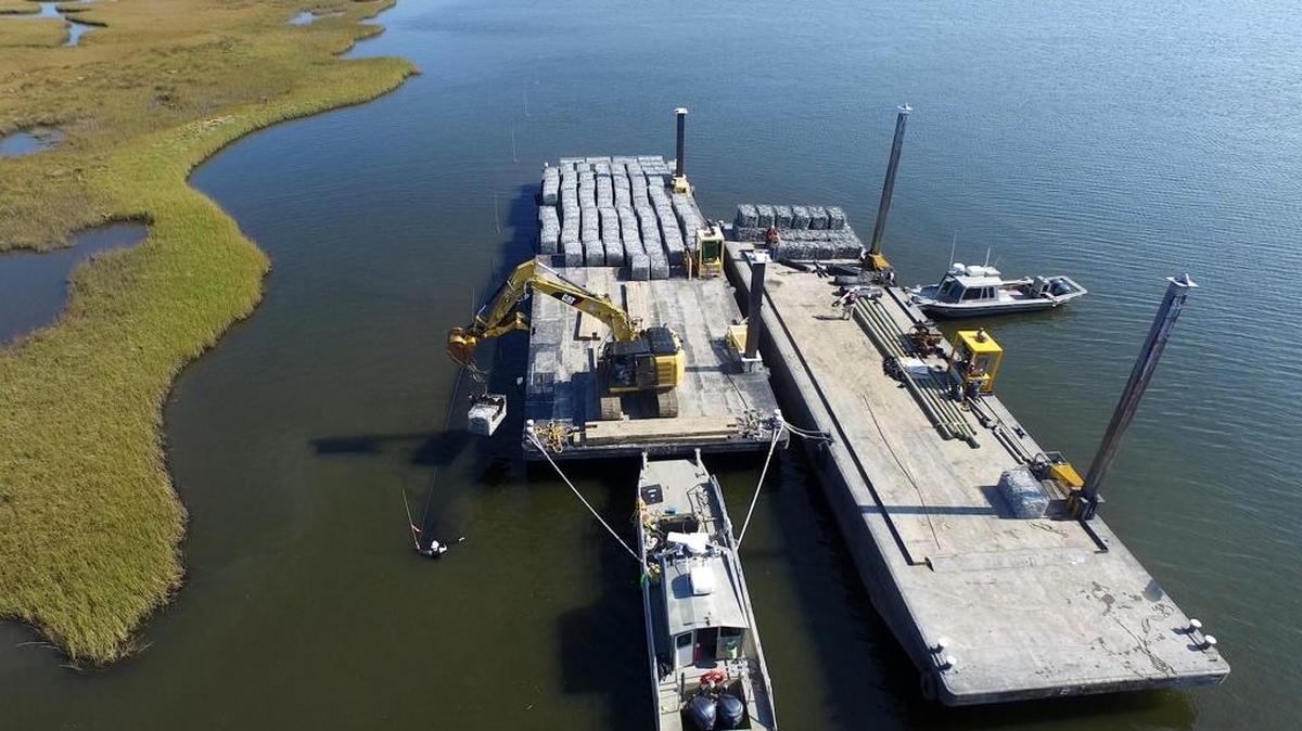 This Nov. 16, 2016 photo provided by the Coalition To Restore Coastal Louisiana shows construction of a reef made from recycled oyster shells in Lake Athanasio, in Saint Bernard, La. The oyster shell recycling program spearheaded by two environmental groups in coordination with area restaurants aims to take a waste product that used to fill landfills and instead make it into a structure that tiny oyster larvae can latch onto and grow. The structures in turn can slow erosion and storm surge that is swiftly eating into Louisiana's coast as well as provide other environmental benefits.