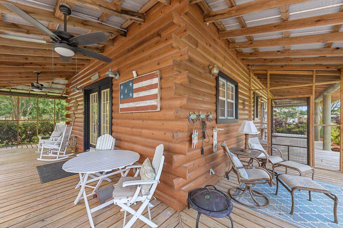 The Waveland home known as Breezy Porches features a wraparound porch that is screened on three sides and open in front. The rear entrance, shown here, overlooks a landscaped courtyard.
