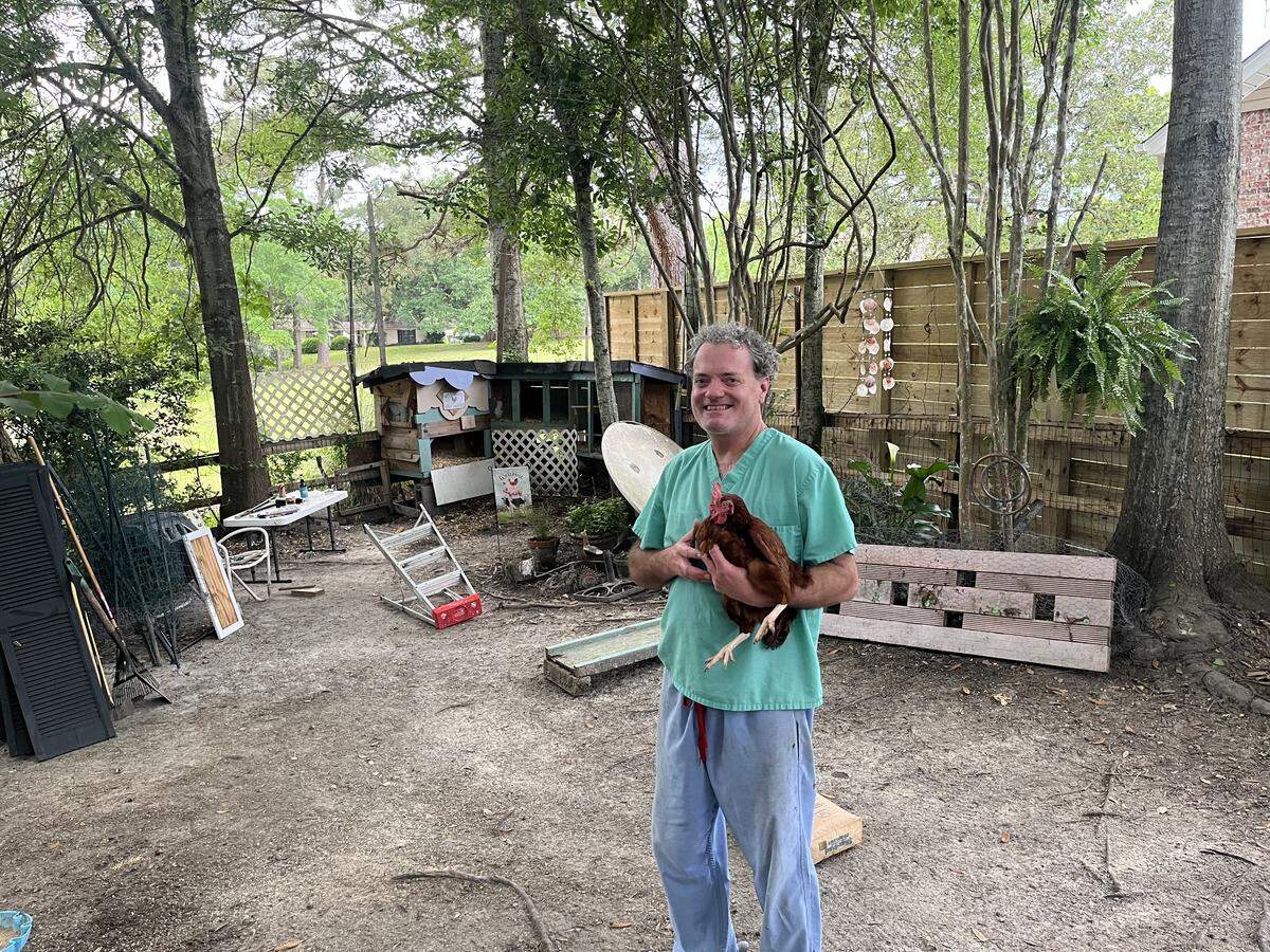 Chris Stebly holds Reddy, his favorite of his wife Jamie Stebly’s eight backyard chickens. Fortunately, he enjoys eggs because the Steblys have plenty of those at their one in the Gulf Hills subdivision of Jackson County.