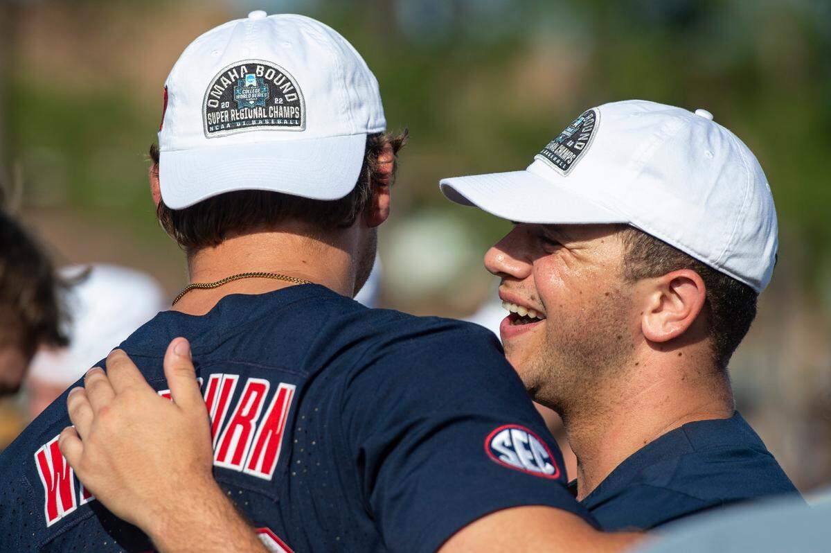 Ole Miss players hug after winning a shot at the College World Series during the Super Regionals Final at Pete Taylor Park in Hattiesburg on Sunday, June 12, 2022.