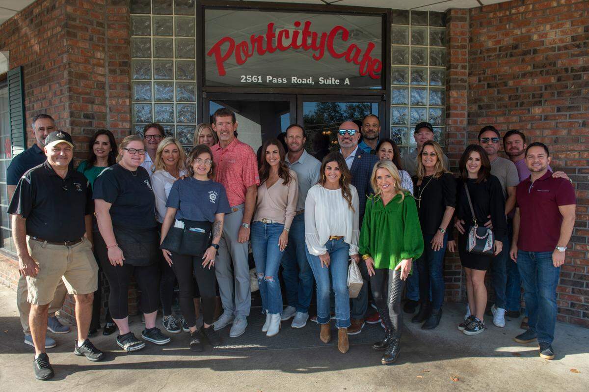 A group of friends from the Mississippi Coast are pictured with Port City Cafe owner Ernest Ulrich, left, and his two waitresses, Lexi Green, of Ocean Springs, and Sidney Searles, of Biloxi. The waitresses were tipped $3,400 tip after the group dined at the restaurant for a Christmas get together in Biloxi on Wednesday.. In 2021, the group left a large tip at Phoenicia Gourmet Restaurant in Ocean Springs.