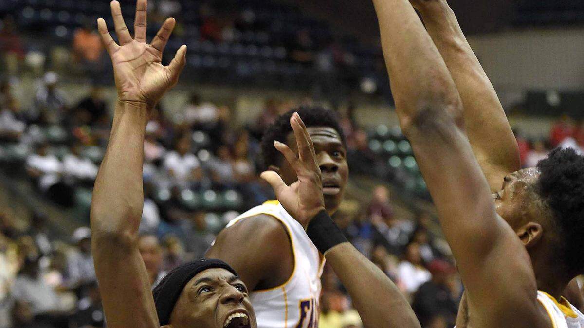 CHRIS TODD/SPECIAL TO THE SUNHERALD 
 George County's Ja'Quan Hawkins (11) puts up an off balance shot against Columbus on Saturday, March 5, 2016, in the MHSAA state basketball tournament quarterfinals at the Mississippi Coliseum in Jackson, Miss.