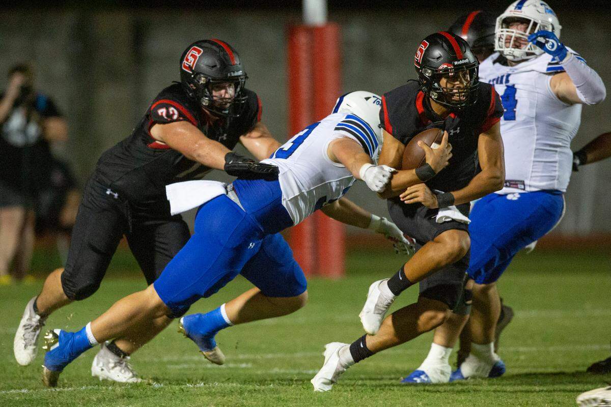 Stone’s defense attempts to tackle St. Stanislaus’ quarterback Ian Gonzales Rioz during a game against the Stone Tomcats at St. Stanislaus High School in Bay St. Louis on Friday, Sept. 29, 2023.
