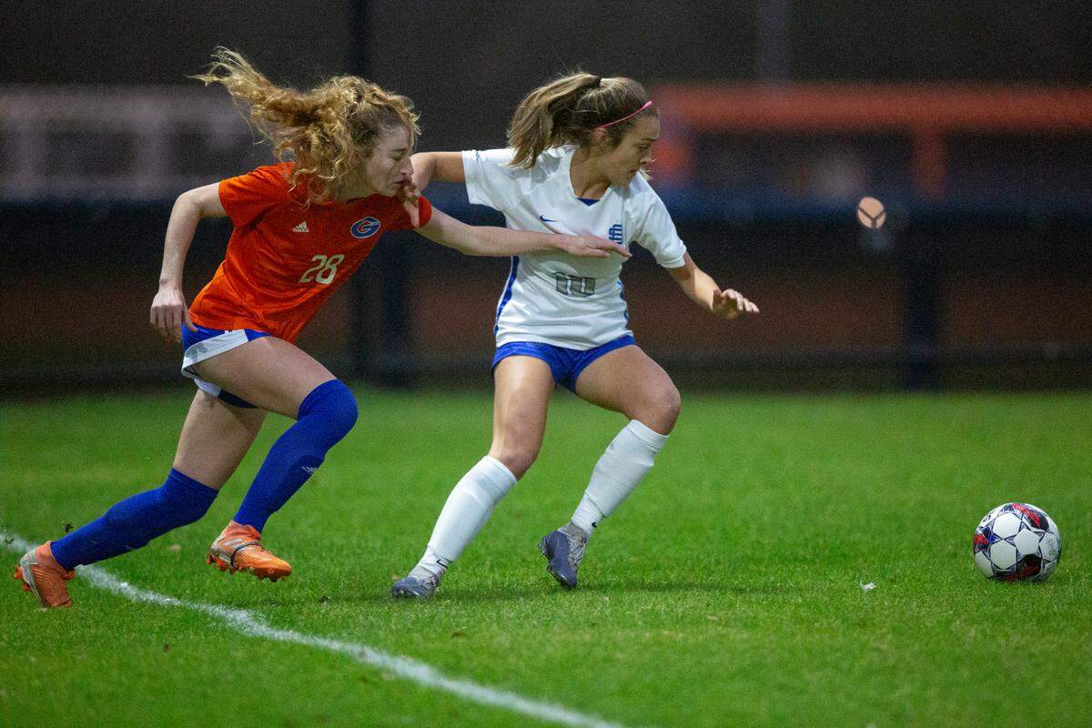 Ocean Springs’ Ashton Rainey and Gulfport’s Mary Frances Symmes fight for the ball during the 6A South State Championship game in Gulfport on Tuesday, Jan. 31, 2023.