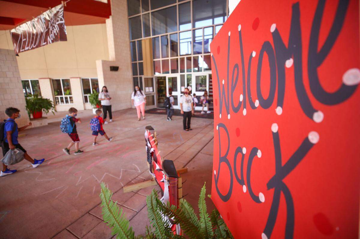 Signs and chalked sidewalks welcome students back to North Bay Elementary August 5, 2020.