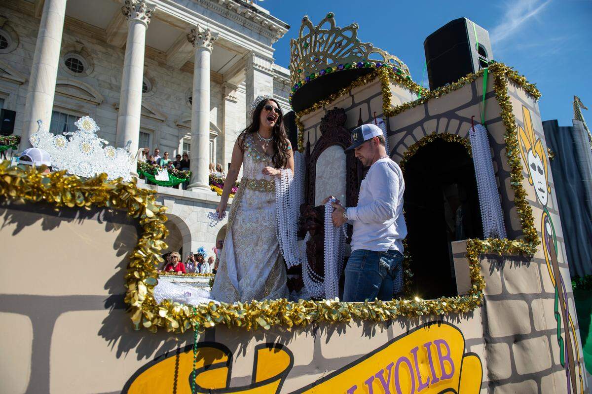 Queen Ixolib Madison Elizabeth Warren tosses beads to the crowd during the Gulf Coast Carnival Association Mardi Gras Parade in Biloxi on Tuesday, March 1, 2022.