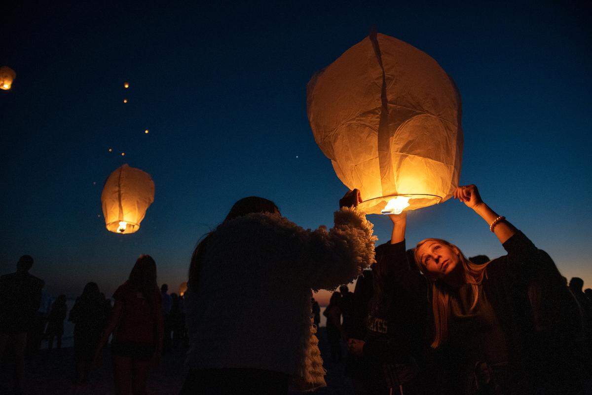 Friends and family of Pass Christian teen Abby Bosarge light lanterns on the beach following her funeral on Tuesday, Nov. 2, 2021.