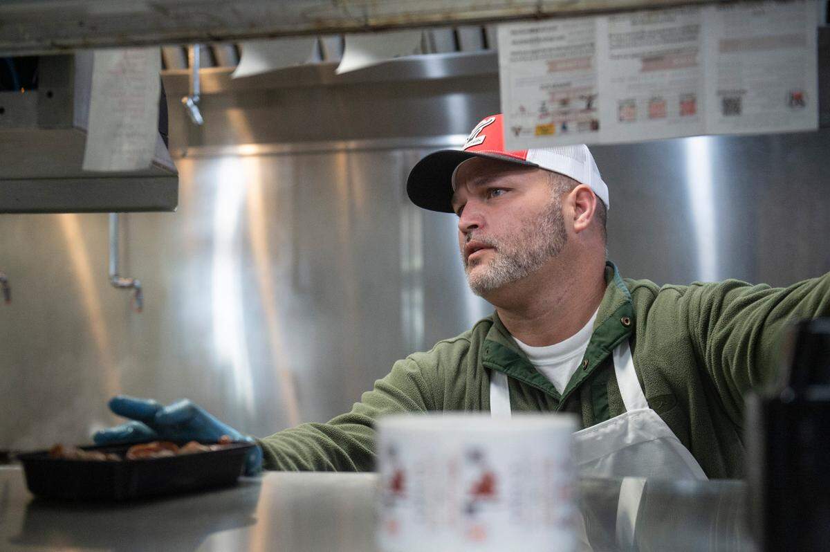 Joseph Mason, who owns 4-Bulls Farm to Table and the adjacent butcher shop, which is supplied by his Alabama farm Mason Hills, serves up a lunch order at 4 Bulls Farm to Table restaurant in Ocean Springs on Monday, Jan. 6, 2025.