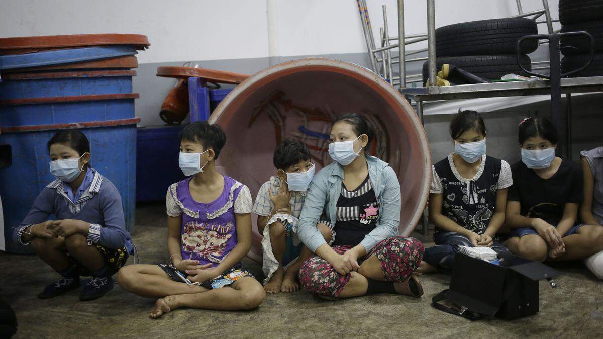 DITA ALANGKARA/ASSOCIATED PRESS 
 Children and teenagers wait to be registered by officials during a raid on a shrimp shed in Samut Sakhon, Thailand. Abuse is common in Samut Sakhon, which attracts workers from some of the worldís poorest countries, mostly from Myanmar."