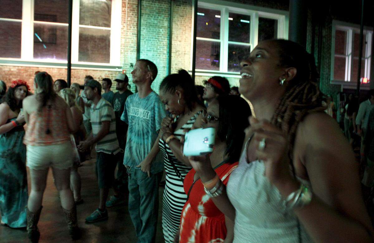 TIM ISBELL/SUN HERALDA crowd dances to Rebirth Brass Band at Kress Live in Biloxi's Vieux Marche in 2014. Biloxi is one of at least four cities considering a downtown leisure district, which would include Vieux Marche, so that customers could carry alcoholic drinks in go cups from one establishment to the next.
