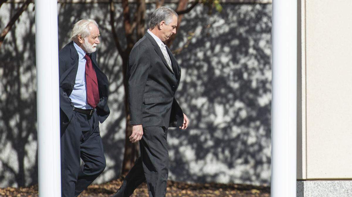 Todd Rosetti, right, sales manager of Quality Poultry & Seafood, and Clell Rosetti, left, a corporate representative of Quality, walk out of the federal courthouse in Gulfport on Wednesday, Dec. 11, 2024, after their sentencing in a federal seafood mislabeling case.