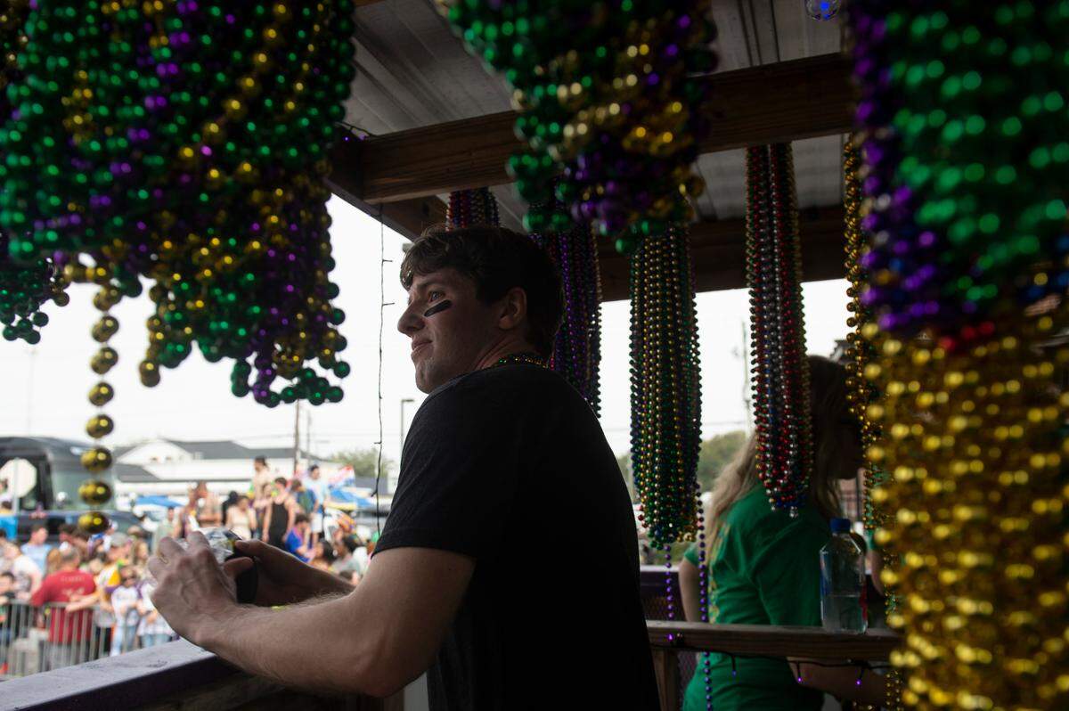 A float rider prepares to toss beads from the BetMGM float during the Gulf Coast Carnival Association Mardi Gras parade in Biloxi on Tuesday, Feb. 21, 2023.