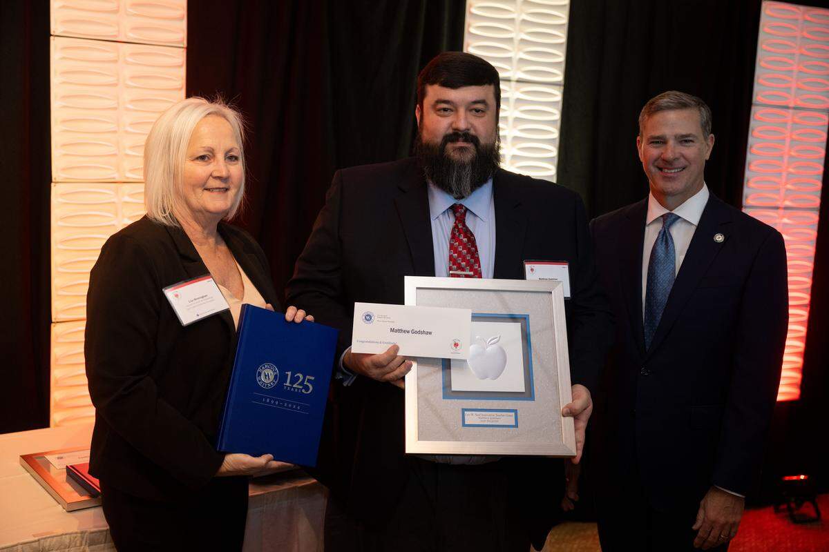 Matthew Godshaw, middle, poses for a photo with Lisa Birmingham, left, and Emory Mayfield.