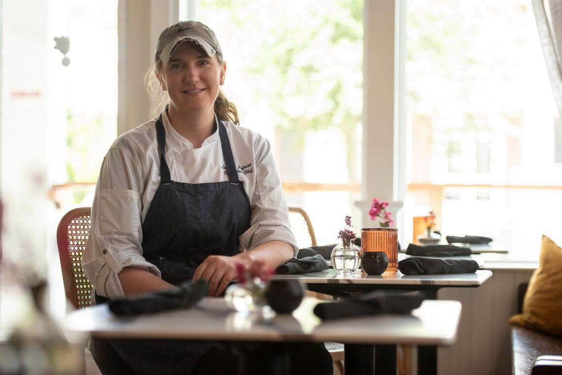 Radish’s chef Lauren Joffrion poses for a portrait at one of the dining tables at Radish, a new restaurant in Long Beach, on Thursday, Aug. 4, 2022.