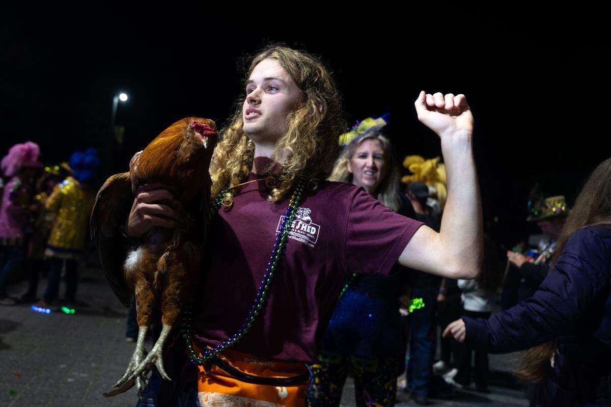 Samuel Earhart dances with Sebastian, his chicken, during a 12th Night Celebration in Biloxi on Monday, Jan. 5, 2026.
