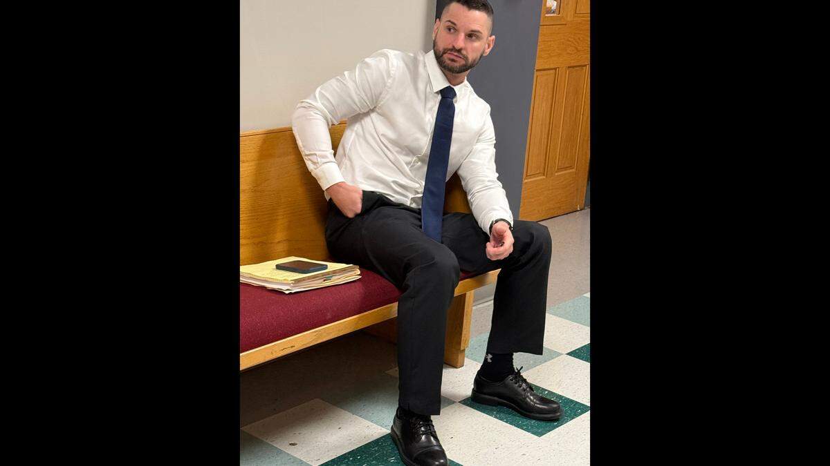 Former Moss Point Police Officer Craig Chandler sits outside Jackson County Court before his domestic violence trial begins before Judge Mark Watts. This is his second trial after he appealed his conviction for the offense in Justice Court.