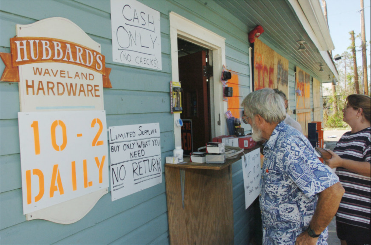 Hubbard’s Hardware opened a window for customers after Hurricane Katrina. The store, pictured here in early October 2005, was only open for limited business after cleaning up the flooding.