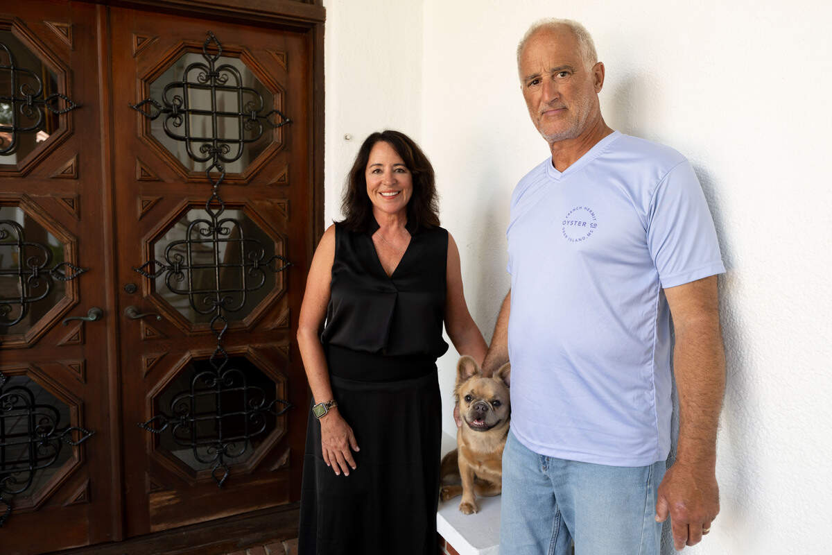 Cecelia Cenac, left, and Greg Cenac, right, stand outside their front door with their long-haired French bulldog Nina at Villa Del Mare at 13801 Arbor Circle in Ocean Springs on Wednesday, May 27, 2026.