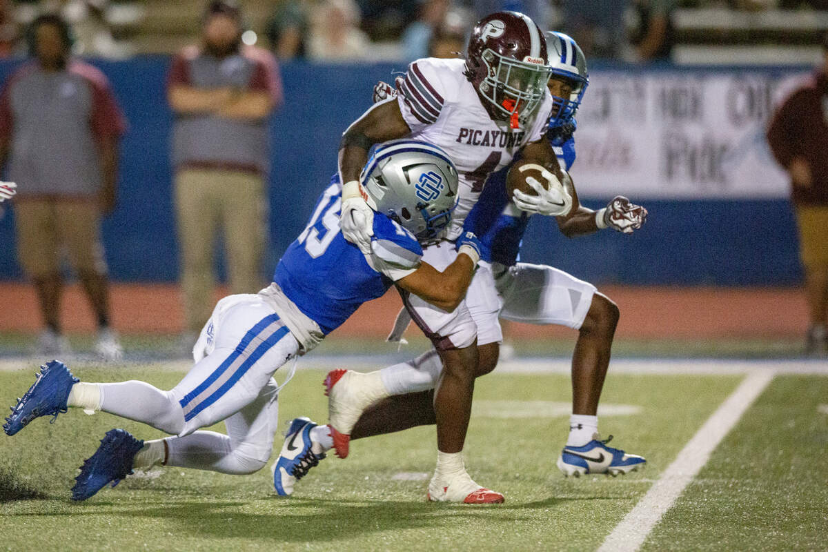 Picayune’s Darrell Smith runs the ball during a game between Picayune and Ocean Springs at Greyhound Stadium in Ocean Springs on Friday, Sept. 27, 2024.