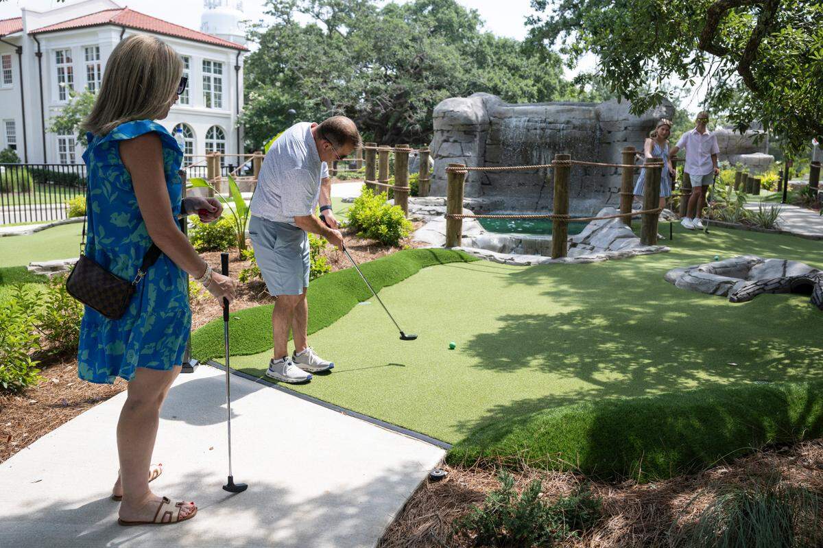 Visitors play mini golf at Hippie Fish at Centennial Plaza in Gulfport on Thursday, June 26, 2025.