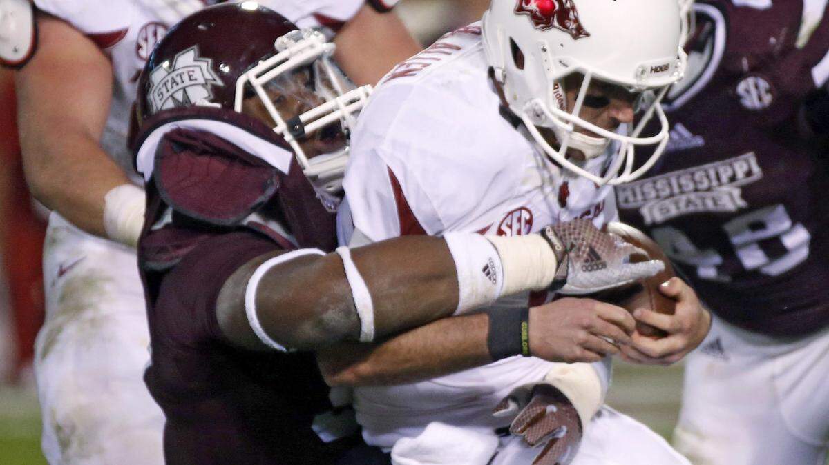 ROGELIO V. SOLIS/ASSOCIATED PRESSArkansas quarterback Brandon Allen (10) is sacked by Mississippi State defensive lineman Chris Jones, left.