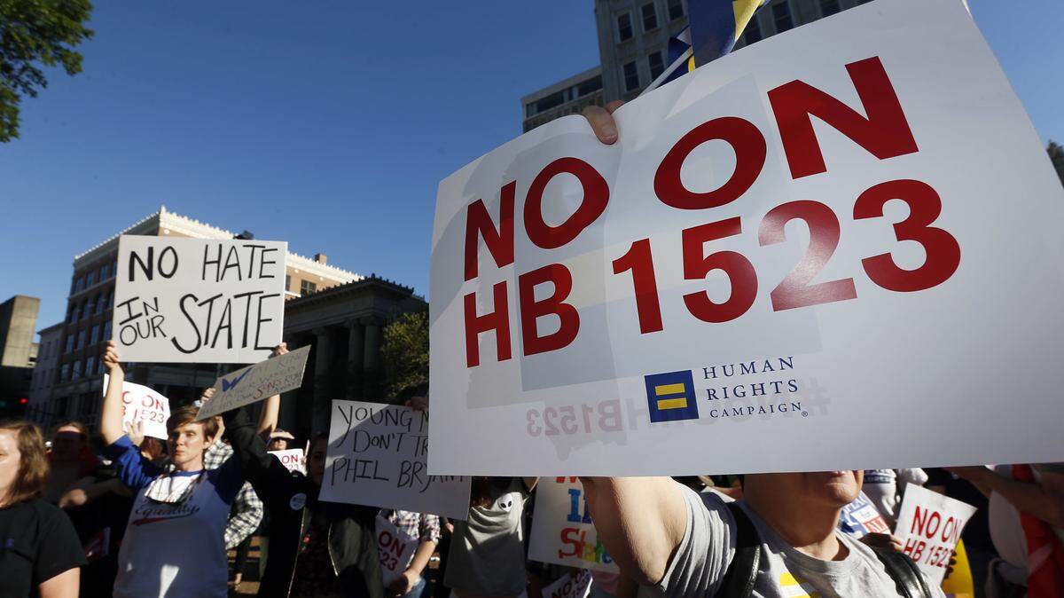 Protesters call for Mississippi Gov. Phil Bryant to veto House Bill 1523, which they say allow discrimination against LGBT people, during a rally outside the Governor's Mansion in Jackson, Miss., Monday, April 4, 2016. (AP Photo/Rogelio V. Solis)