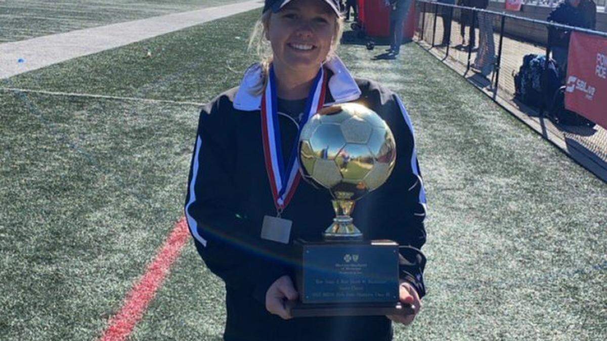 Stone girl’s soccer coach Carissa Harrison with the 4A state title trophy