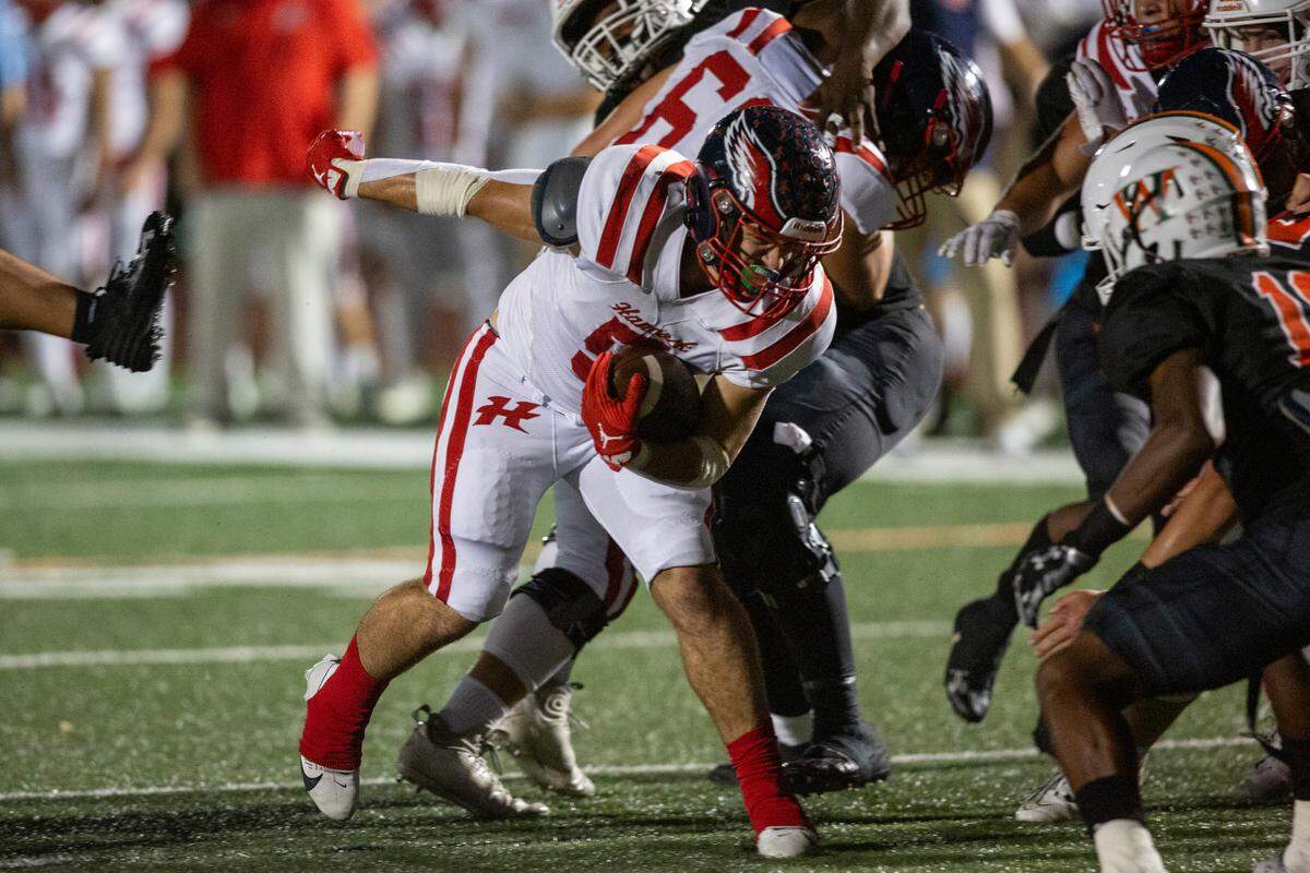 Hancock’s Zachary Gullung runs the ball through West Harrison’s defense during a game at West Harrison High School in Harrison County on Friday, Oct. 6, 2023.