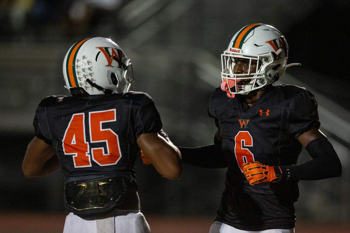 West Harrison Hurricanes’ Jahmad McGowan and Jordan Stapleton celebrate a touchdown during a game against Moss Point at West Harrison High School in Gulfport on Friday, Sept. 22, 2023.