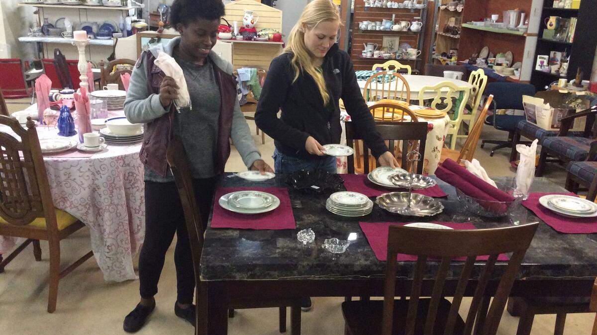 VICKI TERRINONI/SPECIAL TO THE SUN HERALDArukah House Thrift Shop workers Demetrious Jackson and Olivia Hobby, both of Moss Point, set a table with dishes and other housewares to put on a display in preparation for the Pascagoula store's grand opening on Feb. 6.