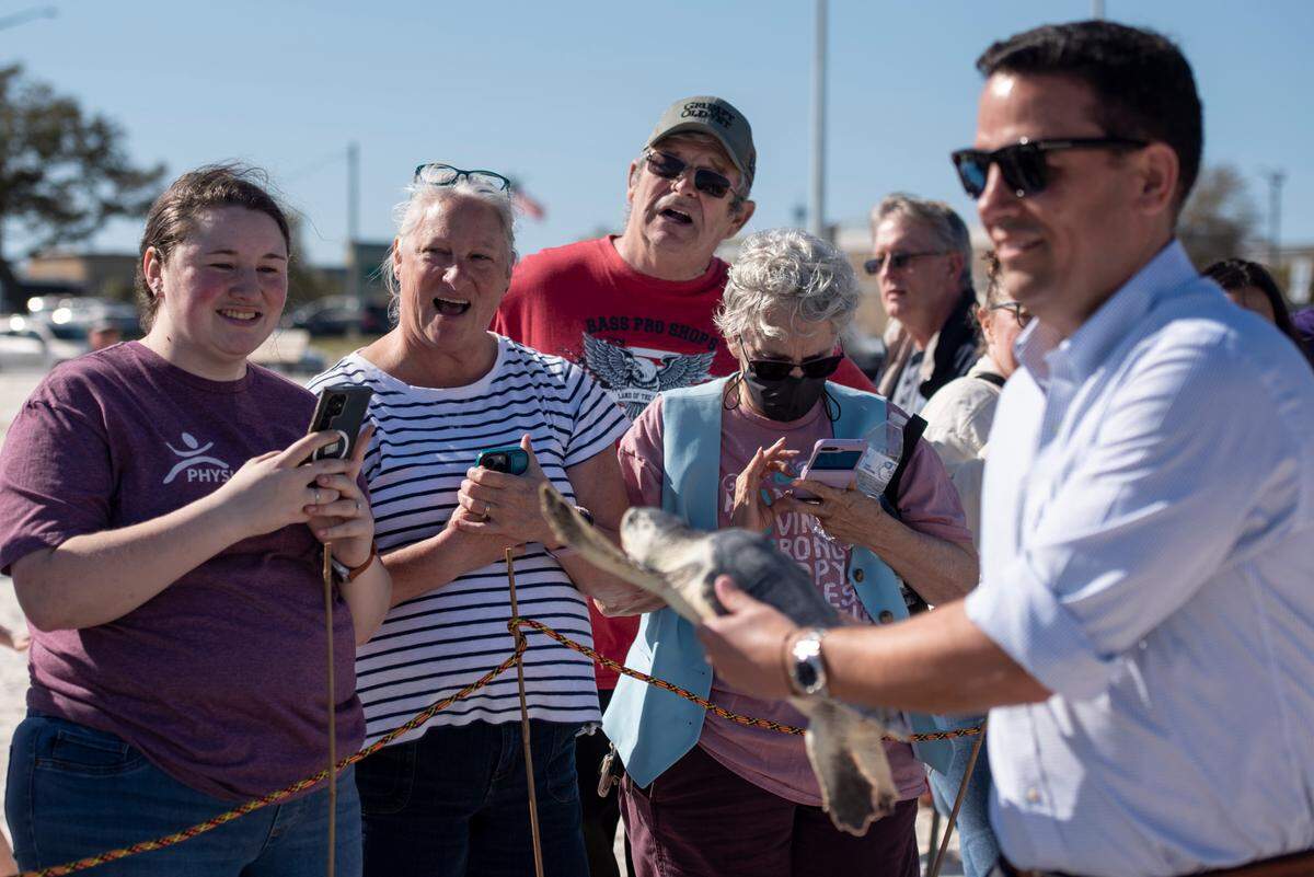 Mississippi Aquarium staff and volunteers release Kemp’s ridley sea turtles back into the Gulf of Mexico from Biloxi Beach on Wednesday, March 12, 2025. The sea turtles, which were rehabilitated by the Mississippi Aquarium for cold-stunning, were named after Taylor Swift songs and given tags resembling friendship bracelets.