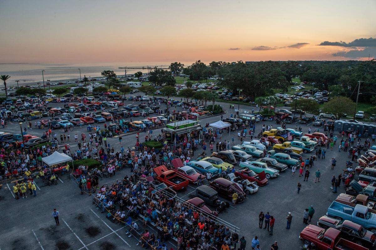 Crowds gather to watch the flame throwing competition, where drivers compete to see which car can produce the biggest flames, at Island View Casino in Gulfport during Cruisin’ The Coast on Tuesday, Oct. 5, 2021.