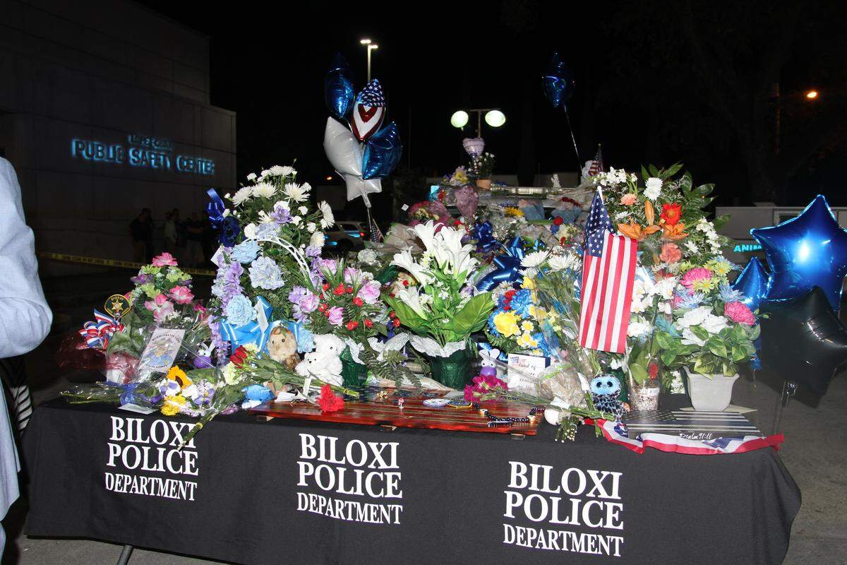 Biloxi police Chief John Miller laid the first bouquet of flowers on the hood of slain officer Robert McKeithen’s SUV on Monday.and the tributes continue to grow. Miller and other Biloxi Police officers joined McKeithen in the rescues at Eagle Point after Hurricane Katrina. McKeithen was among four officers who were awarded the Medal of Valor.