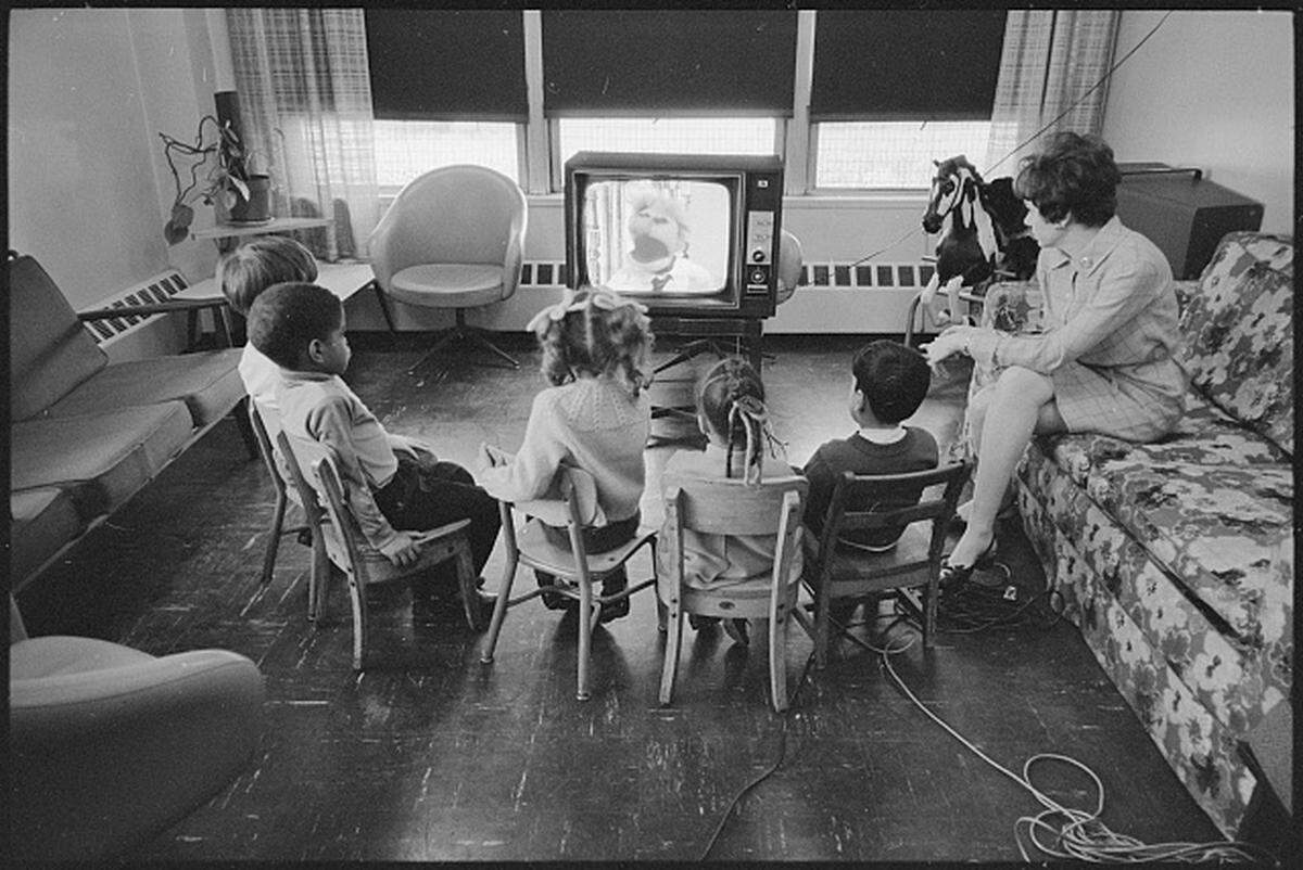 Joan Ganz Cooney and Several Children Watching Sesame Street.