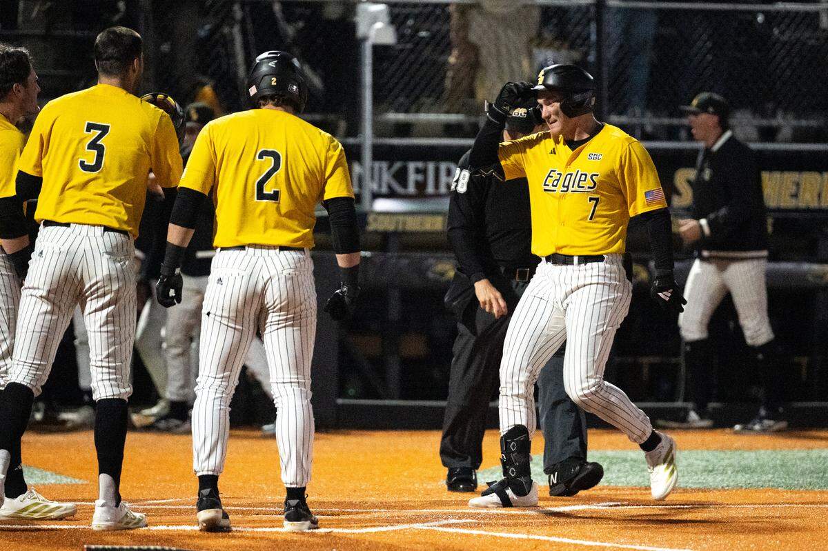 Southern Miss outfielder Ben Higdon (7) celebrates a grand slam with his teammates at home plate during a baseball game at Pete Taylor Park on Tuesday, February. 24, 2026.  Southern Mississippi won 14-4.