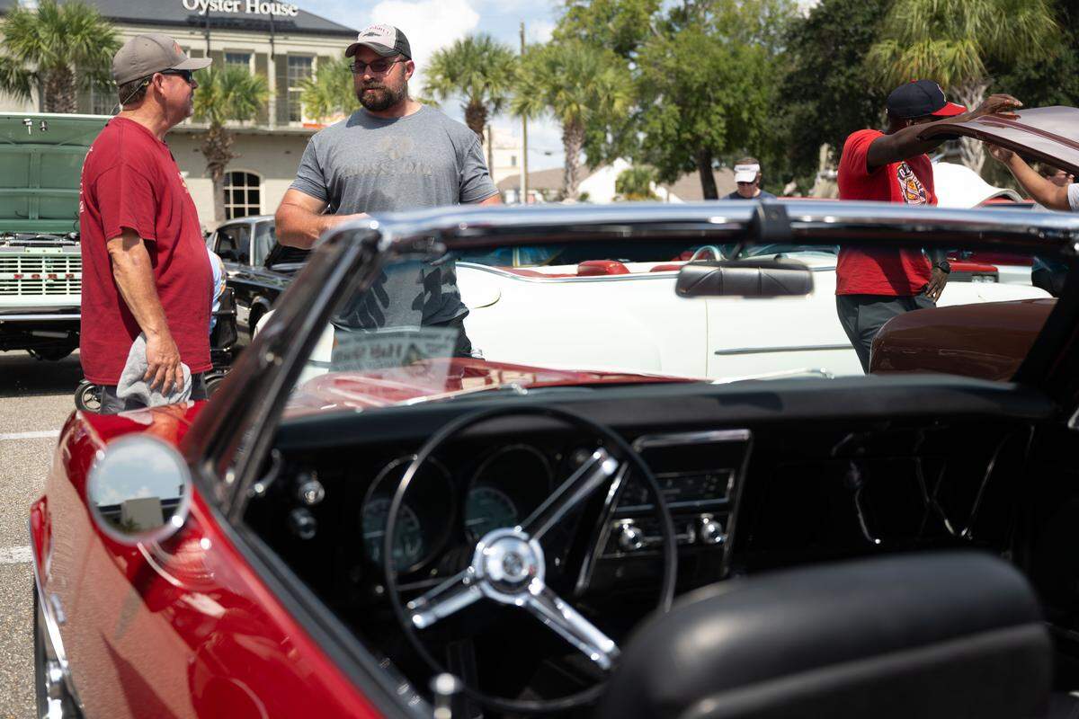 Blane Solar, left, talks to a passerby about his 1967 Chevrolet Camero during the Biloxi Block Party.
