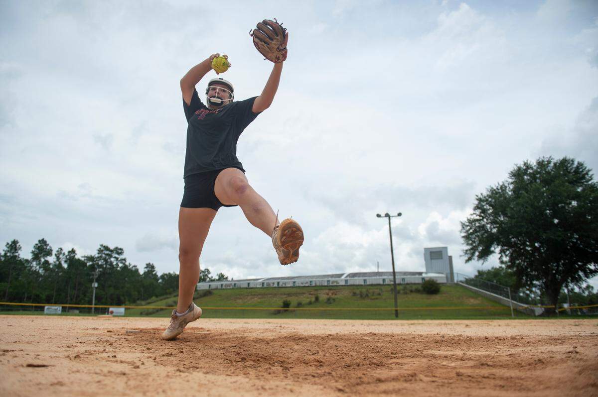 Hancock High School softball pitcher Teegan DeWitt throws a pitch for a portrait at Hancock County Sports Complex in Kiln on Wednesday, July 13, 2022.