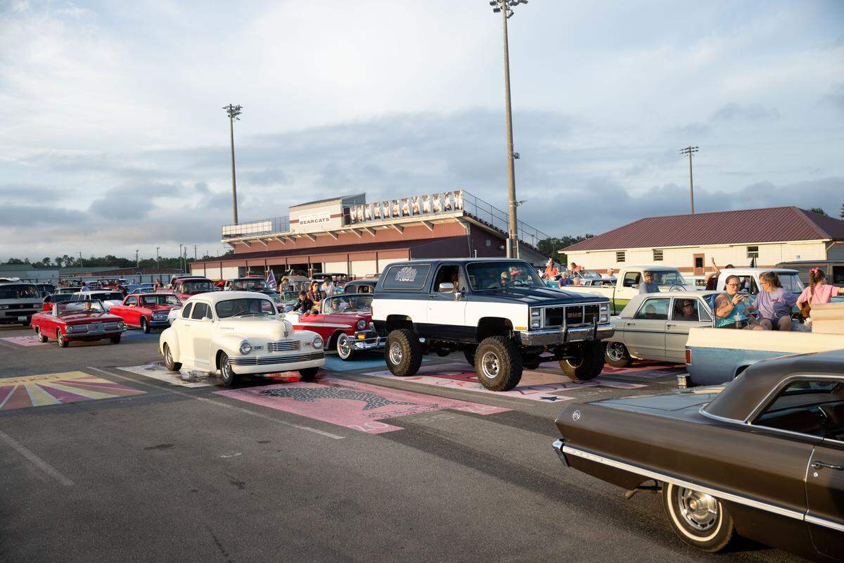 Vintage cars leave the lot of Long Beach High School during the Long Beach Cruisin’ The Coast Parade.