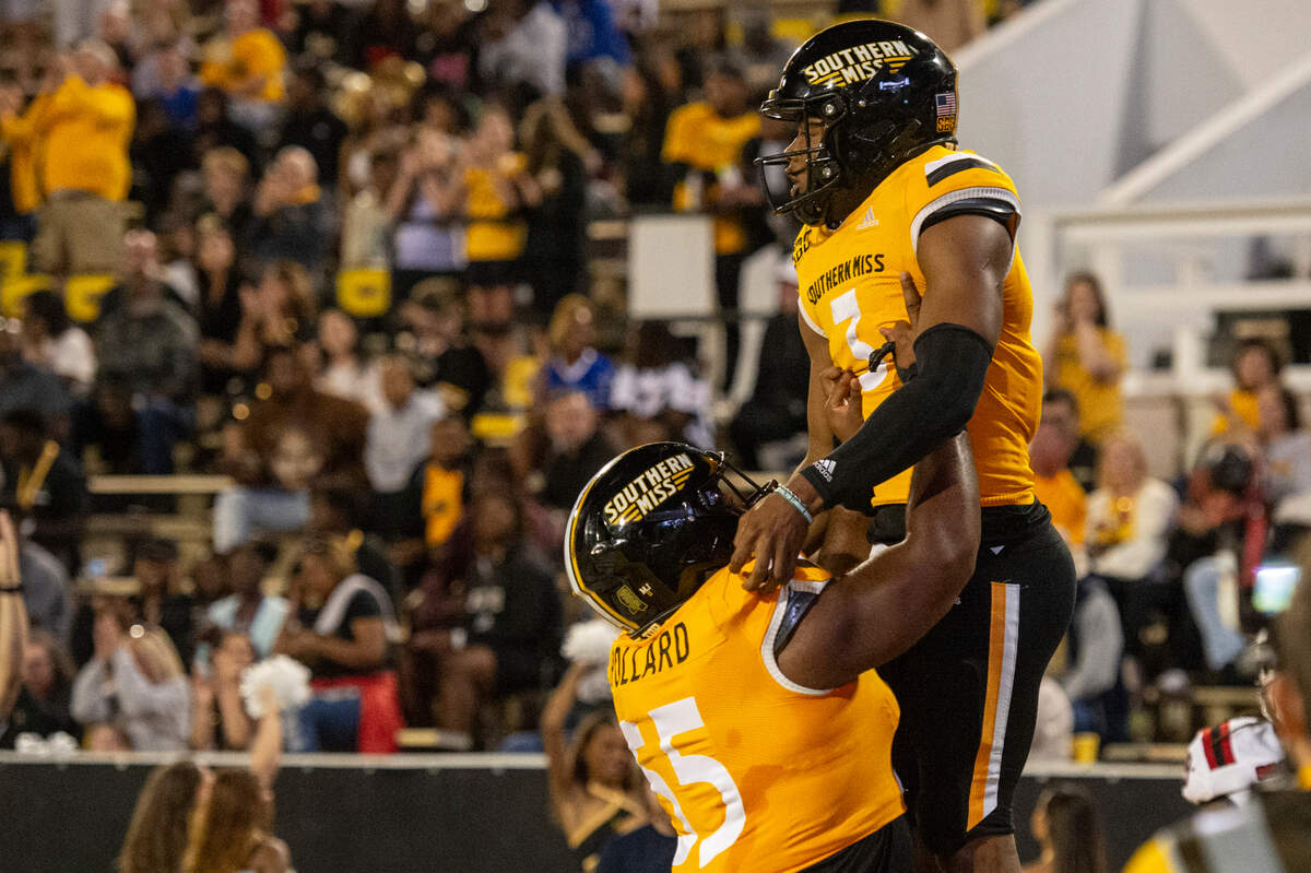 Southern Miss Golden Eagles quarterback Ethan Crawford (3) and Southern Miss Golden Eagles offensive lineman Klabron Pollard (55) celebrate after a touchdown during a game between Southern Miss and Arkansas State at M.M. Roberts Stadium in Hattiesburg on Saturday, Oct. 19, 2024.