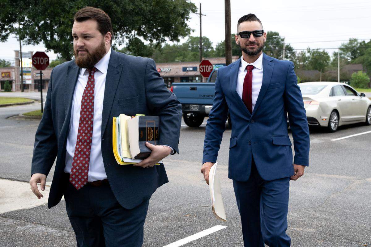 Former Moss Point K-9 Officer Craig Chandler, right, and his attorney, Tyler Cox, walk into Jackson County Justice Court for his first domestic violence trial.