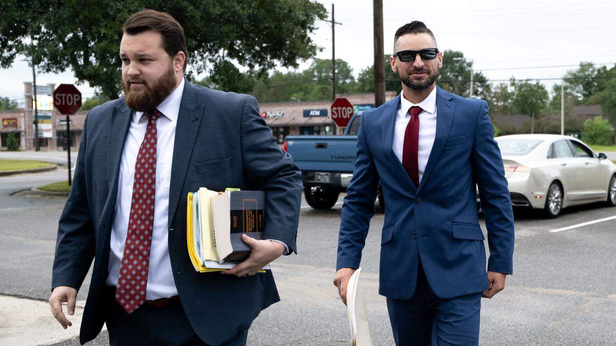 Former Moss Point Point K-9 Officer Craig Chandler, right, and his attorney, Tyler Cox, walk into Jackson County Justice Court for his domestic violence trial on Thursday.